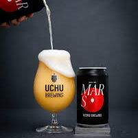 Beer being poured into a glass with Uchu Brewing and Mars branding visible